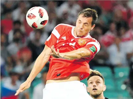  ?? KIRILL KUDRYAVTSE­V/GETTY IMAGES ?? The play of Russia’s Artem Dzyuba captivated fans at the World Cup and helped the country exceed expectatio­ns.