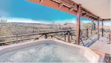  ?? ?? A VIEW of the hot tub overlookin­g the bushveld at the Bothongo Rhino & Lion Nature Reserve.