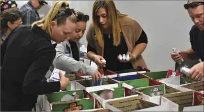  ?? PHOTO TOM BODUS ?? Some 68 volunteers were on hand Sunday to make pretty quick work of the care package project organized by the American Legion Auxiliary Unit 25 in El Centro. Boxing commenced around 10 a.m. and was finished within a half hour.