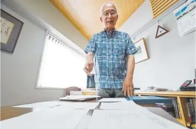  ?? Photos by Eugene Hoshiko, The Associated Press ?? Takeo Hatano, owner of a bookstore, shows the five-page “Yuzawa memo,” written by Michio Yuzawa in 1941 in Tokyo.