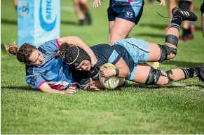  ?? DAVID UNWIN/STUFF ?? Kia Toa lock Mahalia Polson, right, crashes over for a try as Varsity’s Kayla Burnes tries to stop her.