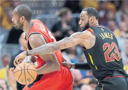  ?? TONY DEJAK/THE ASSOCIATED PRESS ?? In a microcosm of the mercifully short series, the Cavaliers’ LeBron James strips the ball from the Raptors’ Serge Ibaka in the first half in Cleveland on Monday.