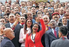  ?? Ariana Cubillos / Associated Press ?? The president of Venezuela’s Constituen­t Assembly, Delcy Rodriguez, leads the newly sworn-in members as they celebrate on Friday.