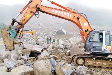  ??  ?? was a Taepodong-1 missile. An excavator works at the site of the landslide in Bijie in China's southweste­rn Guizhou province. — AFP photo