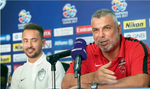  ?? Photo by Dhes Handumon ?? Al Ahli Coach Cosmin Olaroiu speaks during a Press conference prior to their AFC League match against Al Ahli of Saudi Arabia at the Al Ahli Club in Dubai on Sunday. Al Ahli midfielder Everton Ribeiro (left) looks on. —