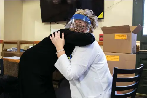  ?? Washington Post photo by Amanda Andrade-Rhoades ?? Ramona Cohen hugs pharmacy manager Kathy Hershey after Hershey gave her a vaccine against COVID-19 on Jan. 15, 2021 in Washington, D.C.