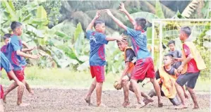  ??  ?? DUA pemain SK Holy Cross (tengah) beradu tenaga menghadang kemaraan pemain pasukan SK Pekan Beluran di peringkat kumpulan. SK Pekan tewas tipis 3 – 4.