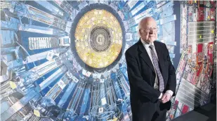  ?? PHOTO: GETTY IMAGES ?? Proof of concept . . . Professor Peter Higgs stands in front of a photograph of the Large Hadron Collider.