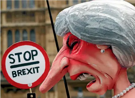  ??  ?? A sculpture depicting Britain’s Prime Minister Theresa May stands opposite Parliament as the protest against Brexit continues in London.