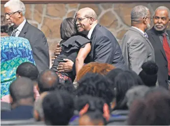  ?? PHOTOS BY LARRY MCCORMACK, THE TENNESSEAN ?? Harry Decour hugs a congregant after prayers for those affected by flooding at Fifth Ward Church of Christ on Sunday in Houston.