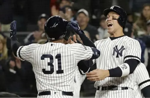  ?? Associated Press ?? The Yankees’ Aaron Hicks (31) celebrates with Aaron Judge after hitting a three-run home run off Justin Verlander in the first inning.