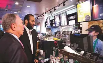  ?? AFP ?? ■ Saudi Crown Prince Mohammad Bin Salman orders coffee with former New York mayor Michael Bloomberg (left) at a coffee shop in New York.