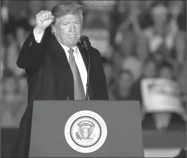  ?? Jeff Roberson/AP ?? Rally: President Donald Trump pumps his fist as he leaves the stage after speaking to supporters during a rally at Southern Illinois Airport on Saturday in Murphysbor­o, Ill.