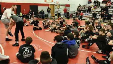  ?? PAUL DICICCO — FOR THE NEWS-HERALD ?? Kyle Snyder demonstrat­es a move for young wrestlers as part of a clinic on Feb. 10 in Mentor.