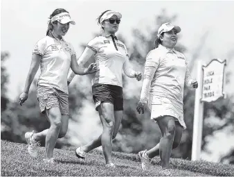  ?? THE ASSOCIATED PRESS ?? South Korean golfers Seung Hyun Lee, left, So Yeon Ryu, center, and Inbee Park walk the course after teeing off the 13th hole during a practice round at the U.S. Women’s Open Golf Championsh­ip at Trump National Golf Club in Bedminster, N.J., on...