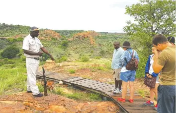  ??  ?? Tour guide Johannes Mokwena takes tourists through the history of the Greater Mapungubwe Kingdom on top of the Mapungubwe Hill, a World Heritage Site