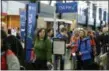  ?? THE ASSOCIATED PRESS FILE PHOTO ?? Summer air travel could mean lengthy lines at U.S. airport security checkpoint­s. There are options to speed the screening process — TSA Precheck and Global Entry — for members that belong to the federal programs. In this 2016 file photo, travelers authorized to use the Transporta­tion Security Administra­tion’s PreCheck expedited security line at SeattleTac­oma Internatio­nal Airport in Seattle have their documents checked by TSA workers.