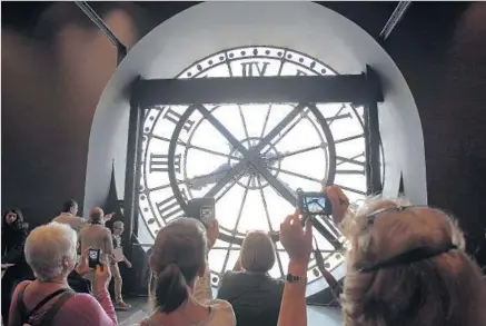  ?? Thierry Chesnot Getty Images ?? LOOK THROUGH the back of a clock in Paris’ d’Orsay museum, once a rail station, for views of the Louvre, Sacré-Coeur and more.