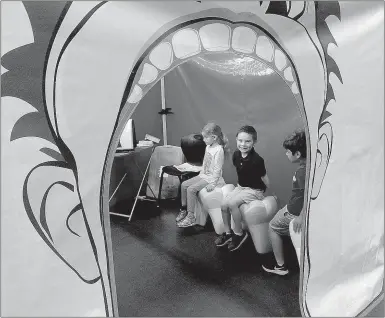  ?? Lynn Atkins/The Weekly Vista ?? Kindergart­en students are seated on giant teeth inside a mouth for a quick lesson on oral hygiene last week at Cooper Elementary School.