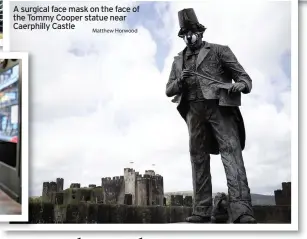  ?? Matthew Horwood ?? A surgical face mask on the face of the Tommy Cooper statue near Caerphilly Castle