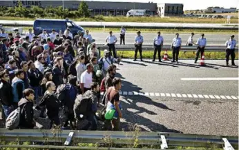  ?? MARTIN LEHMANN/THE ASSOCIATED PRESS ?? The sight of hundreds of Syrian refugees walking through Denmark last September provoked many of the country’s citizens to help out, an act that has led Danish authoritie­s to press people-smuggling charges.