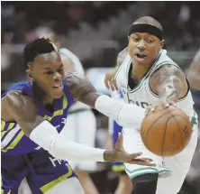  ?? AP PHOTO ?? TWO FOR ONE: Isaiah Thomas and Dennis Schroder fight for a loose ball during their game Friday night.