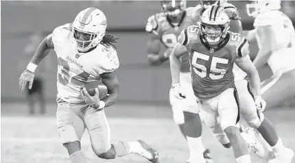  ?? MIKE MCCARN/AP ?? Senorise Perry (34) has made the most of his opportunit­ies in the preseason but his future will depend on whether the Dolphins decide to keep three running backs or four.