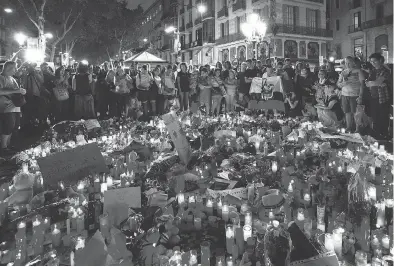  ?? EMILIO MORENATTI / THE ASSOCIATED PRESS ?? People gather in Barcelona Friday at a memorial for the victims of Thursday’s deadly attack.