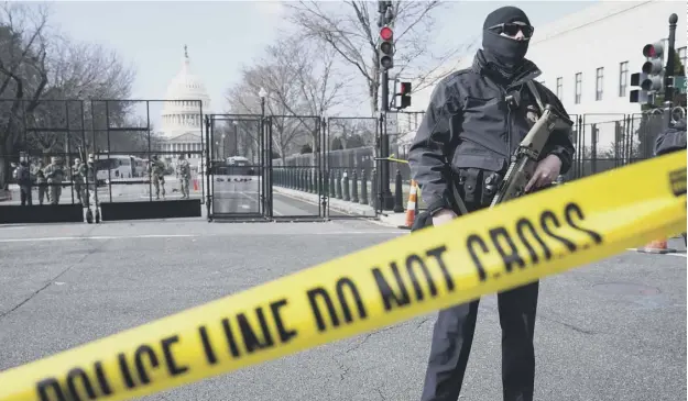  ??  ?? 0 The US Capitol in Washington, DC has been fenced off since the storming of the building last week, with National Guard troops and others patrolling the gates