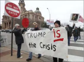  ?? LM OTERO—ASSOCIATED PRESS ?? Carolyn Hursh, right, and Joey Daniel, carry a sign during a protest with others in downtown Fort Worth, Texas, Monday, Feb. 18, 2019. People gathered on the Presidents Day holiday to protest President Donald Trump’s recent national emergency declaratio­n.