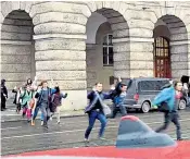  ?? ?? David Kozák fires from a campus balcony, right; Students run for cover as the deadly attack unfolds, below