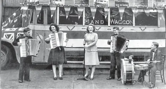  ??  ?? Musicians, from left, Robert Crighton, Mary Alexander (nee Penny), Bebe Richardson (nee Murray), Hamilton Scott and Tommy McDonald in front of a decorated McLennan’s bus. Read more below right.