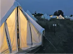  ?? PHOTO BY LAURA MARTIN ?? Canvas tents with electricit­y, comfortabl­e beds and even a safe for valuables seem inviting in a rainstorm.