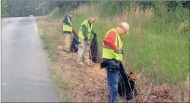  ?? Doug Walker ?? County employees had their work cut out for them Friday during a litter pickup event. The ditch on the east side of Nichols Road was particular­ly full of trash.