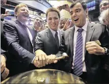  ?? ASSOCIATED PRESS 2014 ?? Mobileye President and CEO Ziv Aviramon (from left), CFO Ofer Maharshak and Chairman Amnon Shashua clasp hands to ring a ceremonial bell on the floor of the New York Stock Exchange as their company’s IPO begins trading in 2014.