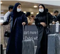  ?? Reuters File ?? PREVENTING SPREAD OF GERMS: Travellers wear masks at a Dubai airport in the wake of the outbreak. —