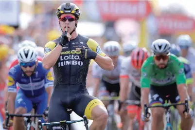  ?? — Reuters ?? Lottonl-jumbo rider Dylan Groenewege­n of the Netherland­s wins the seventh stage of 2018 Tour de France, ahead of Quick-step Floors rider Fernando Gaviria of Colombia and Bora-hansgrohe rider Peter Sagan of Slovakia.