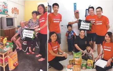  ??  ?? Kechara Soup Kitchen staff and volunteers presenting sundry goods to families.