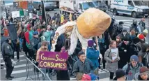  ?? Photo: REUTERS ?? Blood-sucker: Protesters affiliated with the Occupy Wall Street movement carry a puppet of a squid during a march to the offices of Goldman Sachs in New York, in reference to a Rolling Stone article in which Goldman Sachs was described as ‘‘a great...