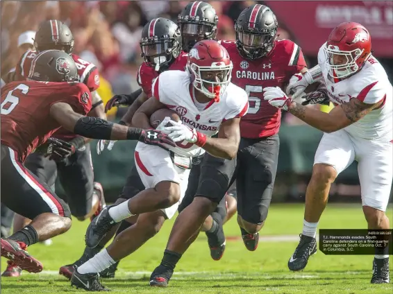  ?? PHOTO BY BEN GOFF ?? T.J. Hammonds evades South Carolina defenders on a first-quarter carry against South Carolina Oct. 7 in Columbia, S.C.