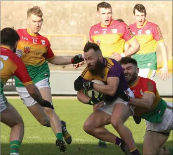  ??  ?? A determined Conor Carty is surrounded by a small army of Carlow opponents.