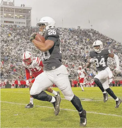  ?? | CHRIS KNIGHT/ AP ?? Penn State standout Saquon Barkley scores on a 65- yard run in the first minute Saturday against Nebraska.