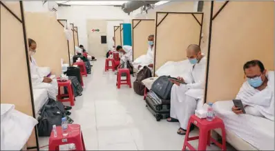  ?? (AFP) ?? Muslim pilgrims rest at their camp in Mina, which sits in a narrow valley near the holy city of Mecca on Sunday.