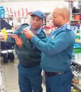  ?? ?? Shane Davidson, Motor Vehicle Licence Inspector at the Department of Transport, and Dennis Fortuin, Head of Protective Services for the Dr Beyers Naudeé Local Municipali­ty, inspecting the expiry date of products during a raid in Graaff-Reinet in June last year.