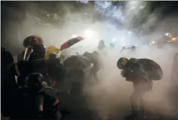  ?? MARCIO JOSE SANCHEZ — THE ASSOCIATED PRESS ?? Federal officers launch tear gas at demonstrat­ors in Portland, Ore., on July 26.