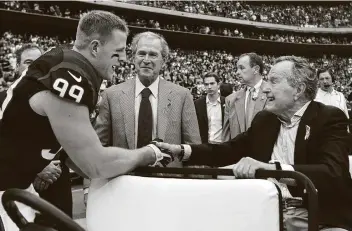  ?? Brett Coomer / Staff file photos ?? Texans defensive end J.J. Watt greets former Presidents George W. Bush and George H.W. Bush before a game against the Oakland Raiders in 2013. As excellent as Watt was on the field, he was just as valuable off the field.
