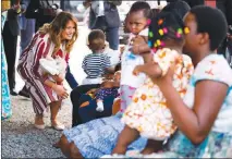  ?? DOUG MILLS/ THE NEW YORK TIMES FILE ?? First lady Melania Trump hands out teddy bears and blankets to young children and their mothers Oct. 2 at the Greater Accra Regional Hospital in Accra, Ghana. Ivanka Trump reacted to news of the first lady’s Africa trip by having her own aides send a message: She was planning her own trip too.