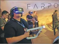  ?? BLOOMBERG ?? Attendees use Sony PlayStatio­n VR Aim Controller­s to play Farpoint during an expo in Los Angeles, California.