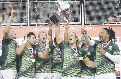  ?? Picture: AFP ?? ANOTHER CROWN. Werner Kok raises the trophy surrounded by his Blitzboks team-mates after beating Fiji in the final of the Las Vegas Sevens on Sunday.