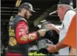  ?? JULIE JACOBSON — THE ASSOCIATED PRESS ?? Martin Truex Jr. signs an autograph before practice Aug. 4 in Watkins Glen, N.Y.